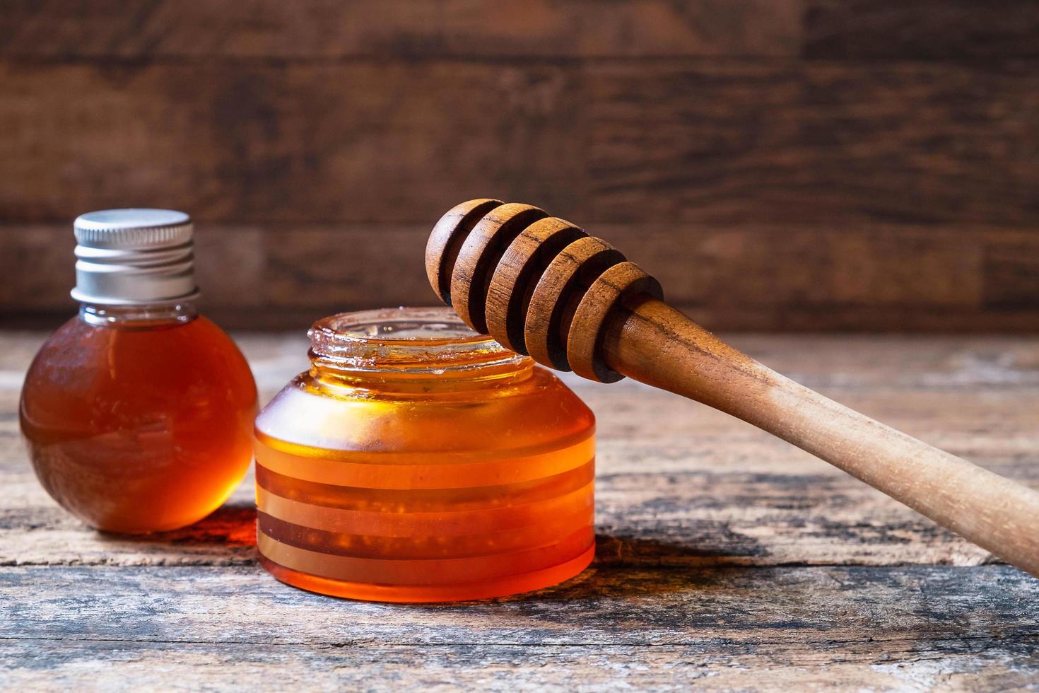 Organic honey on wooden table photo