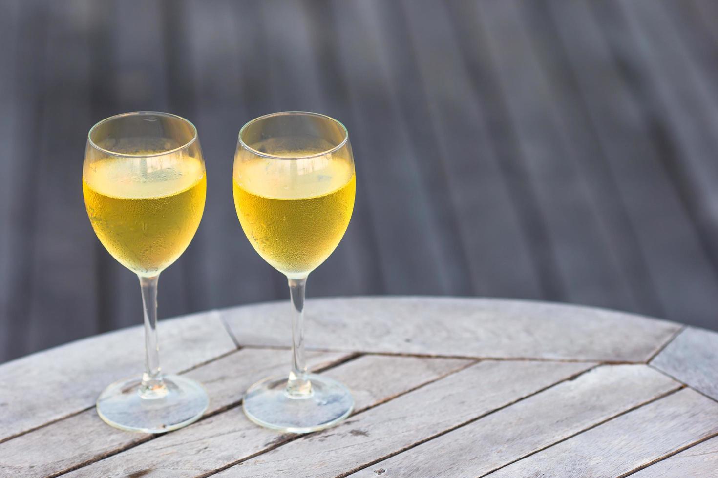 Two glasses of white on a table photo