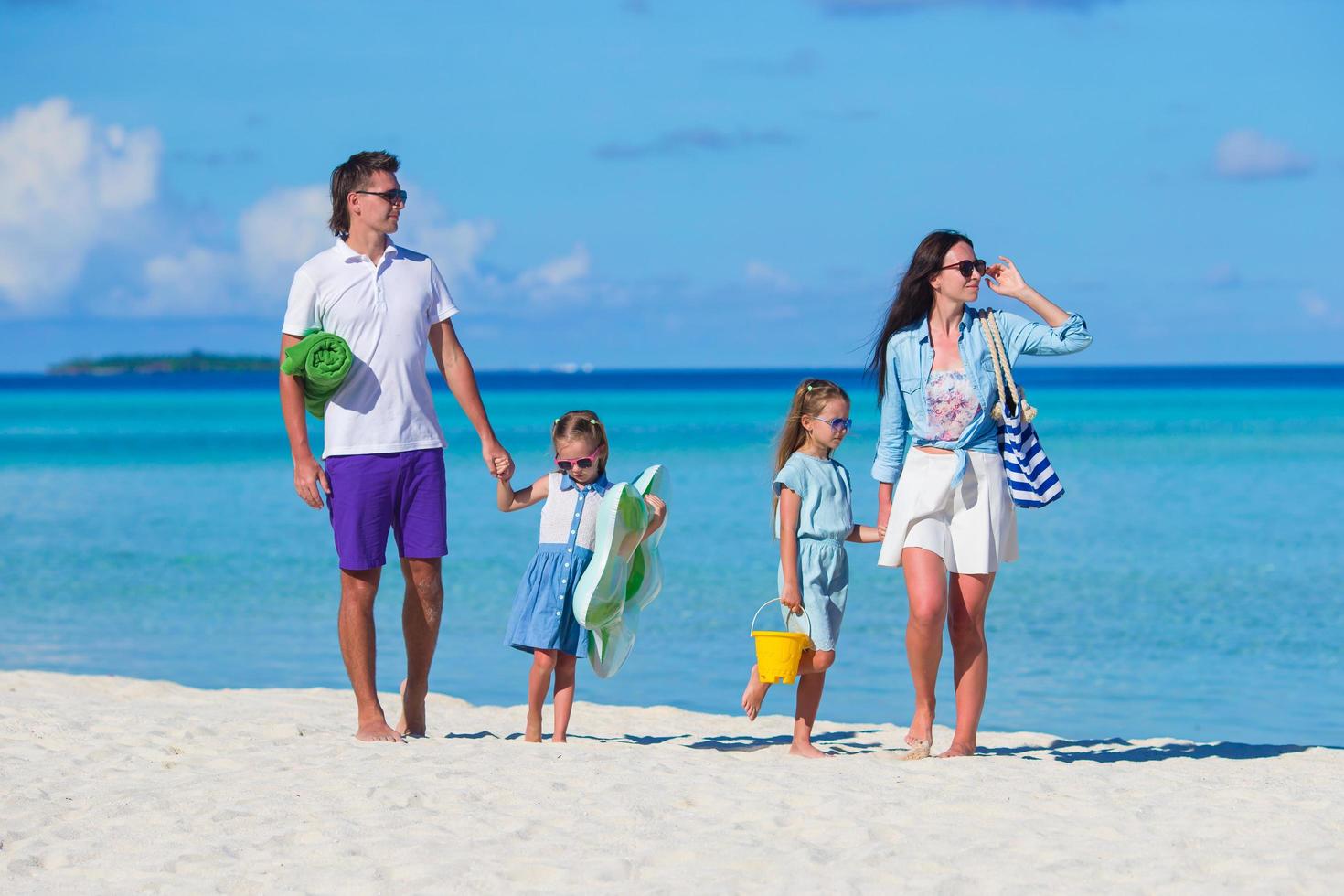 Parents and children on a beach photo