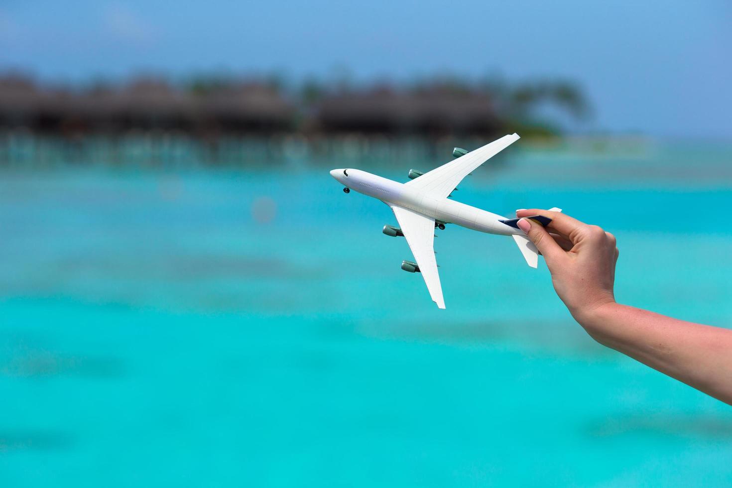 Close-up of person playing with a toy airplane photo