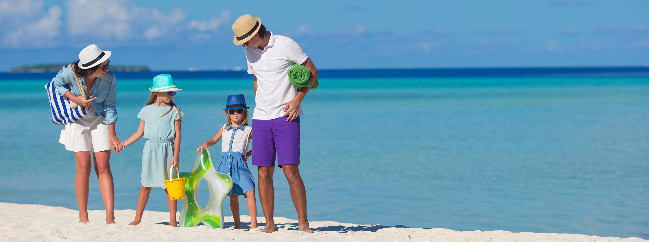 Family on a beach on summer vacation photo