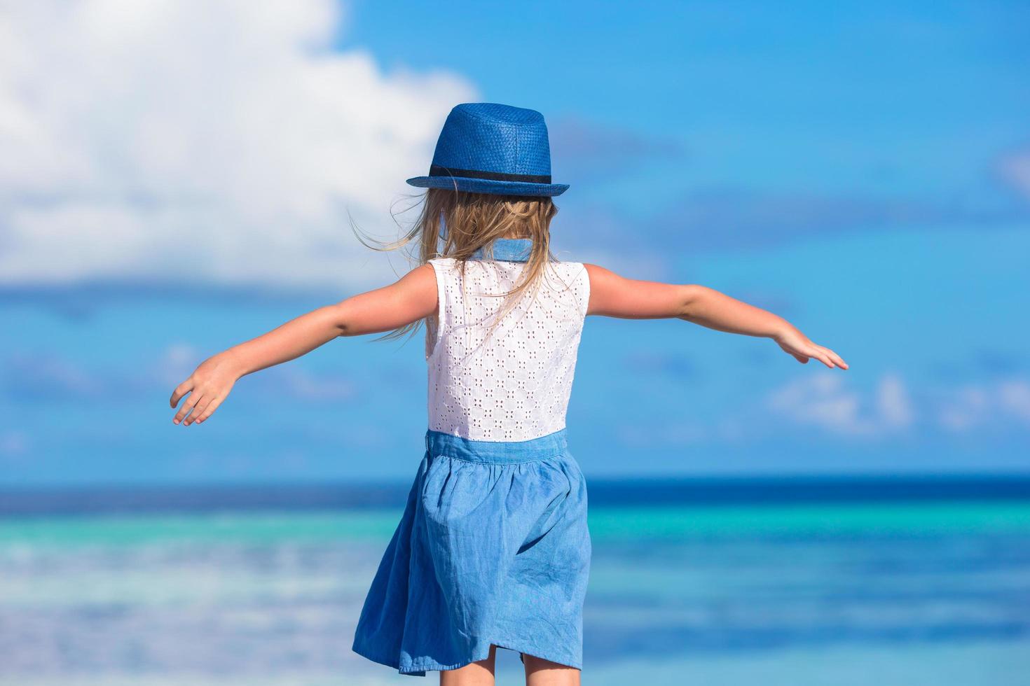 Girl with open arms on a beach photo