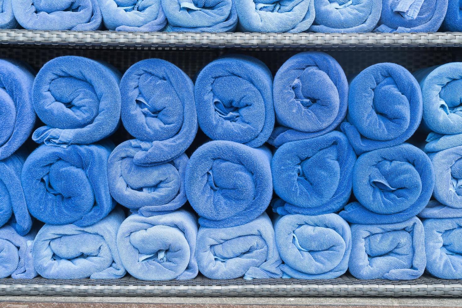 Blue towel roll stack on shelf photo