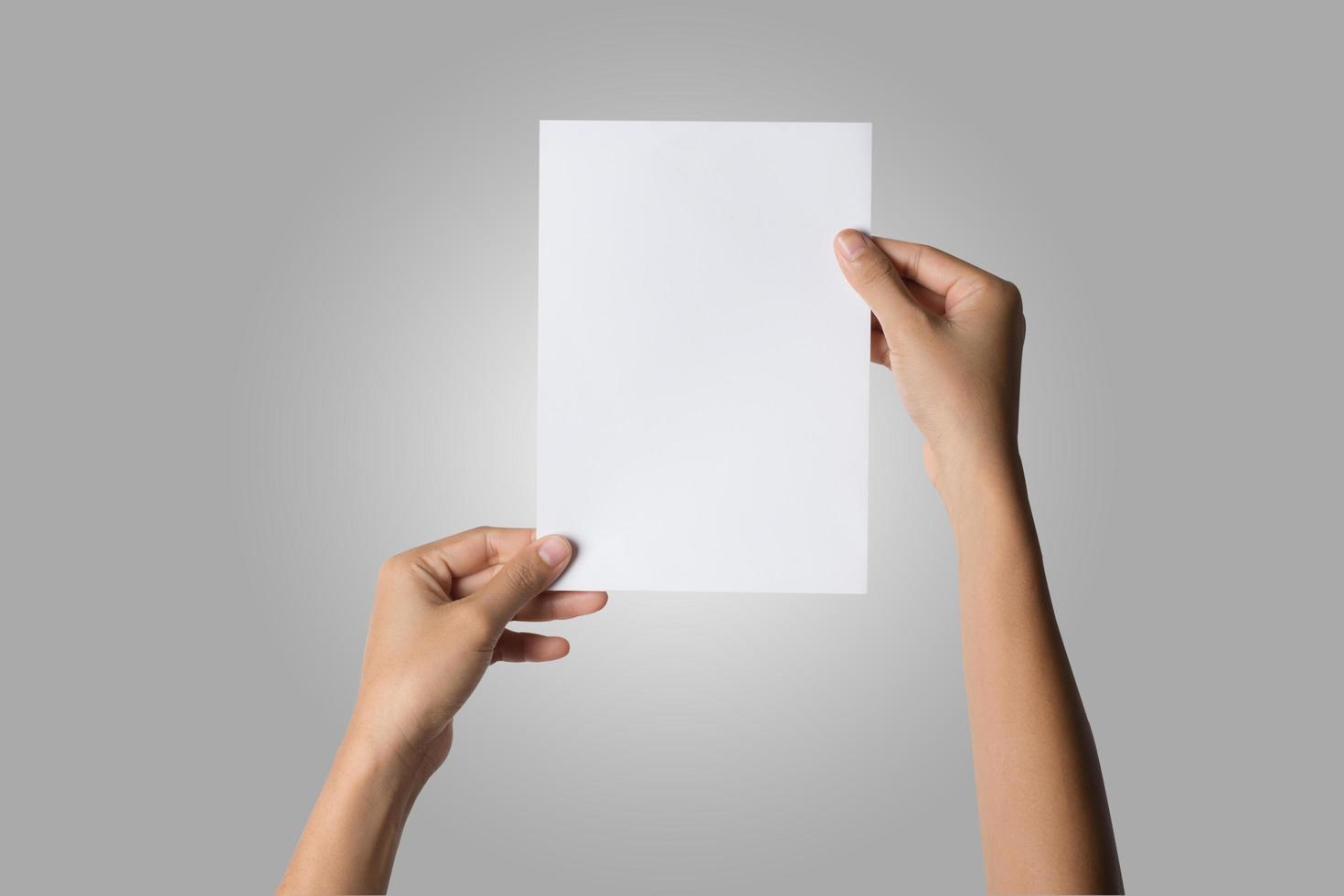 Close-up of a woman's hand holding blank paper isolated on white background photo