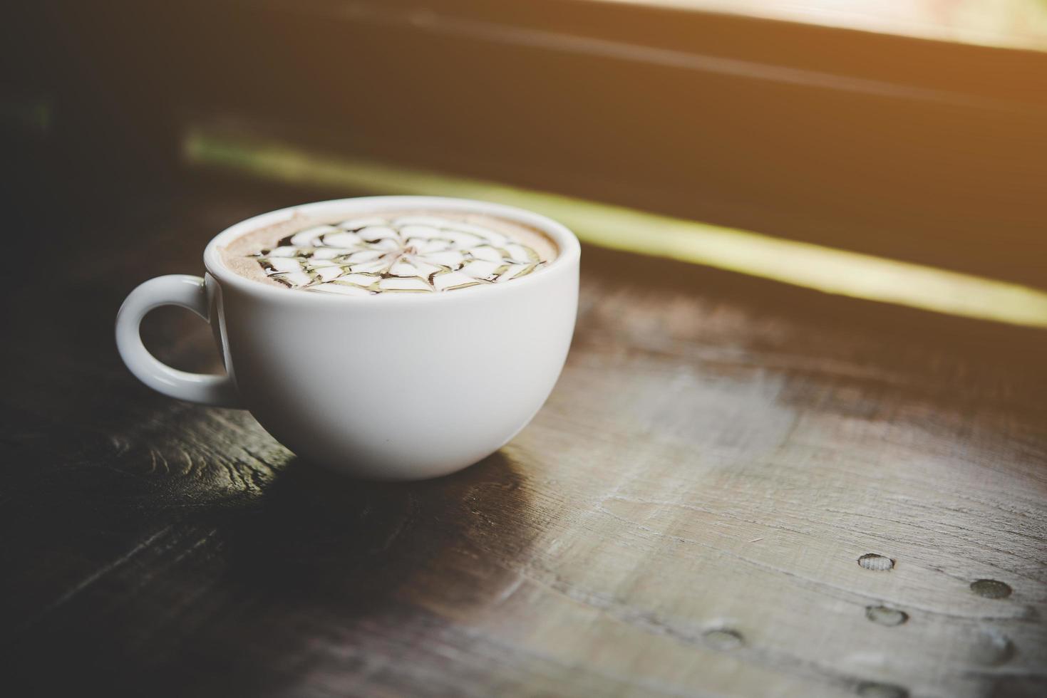 A cup of coffee on wooden table photo