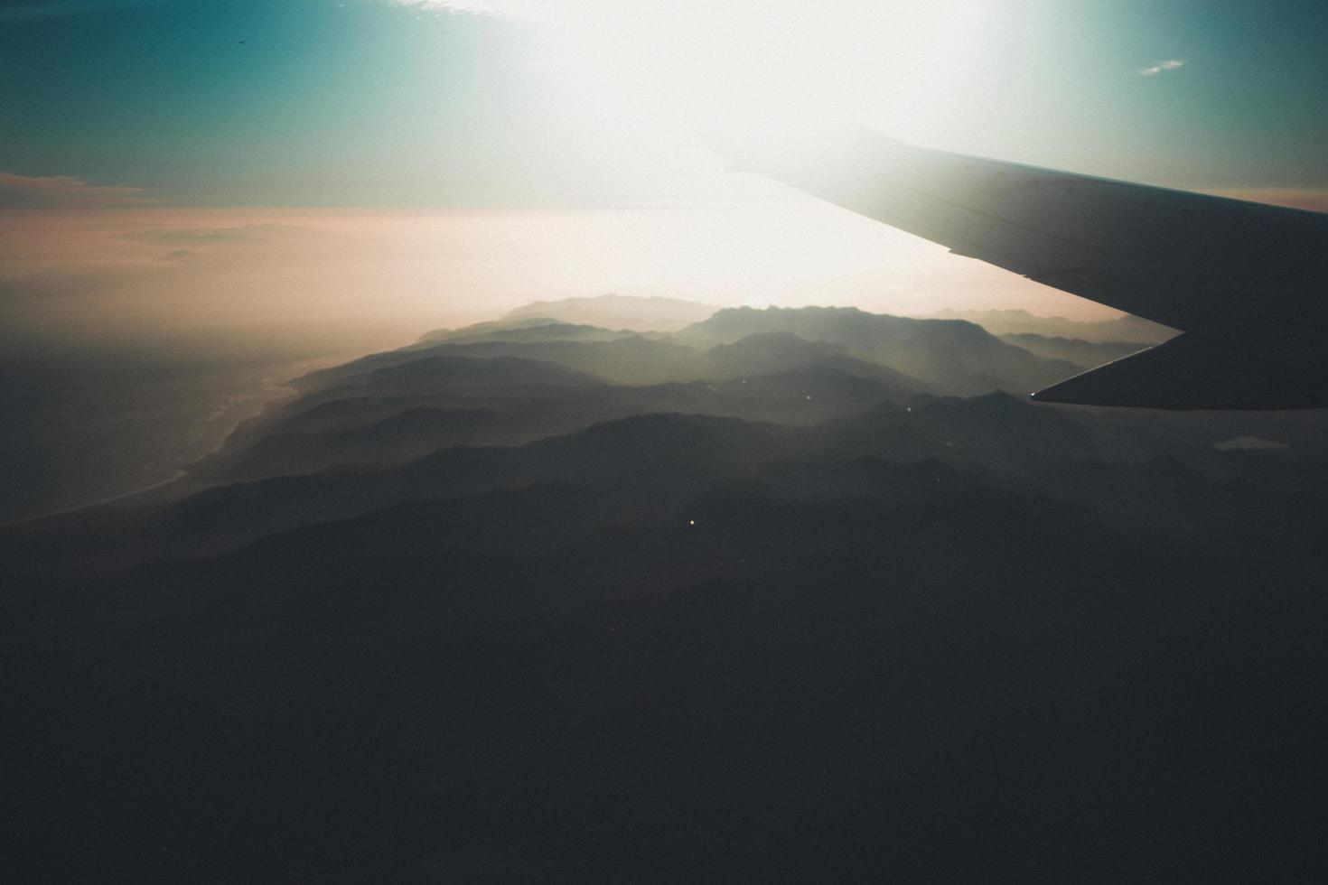 Airplane wing in the sky at sunset photo