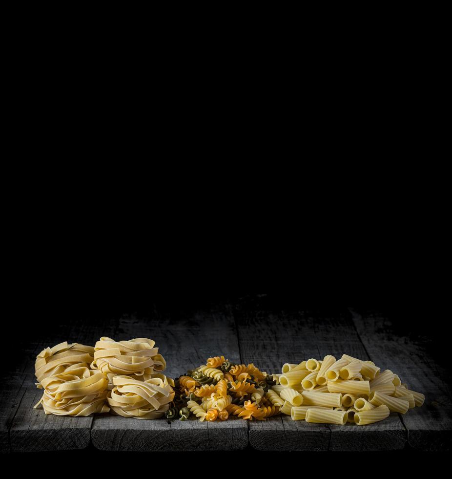 Fresh pasta on wood in front of a black background photo
