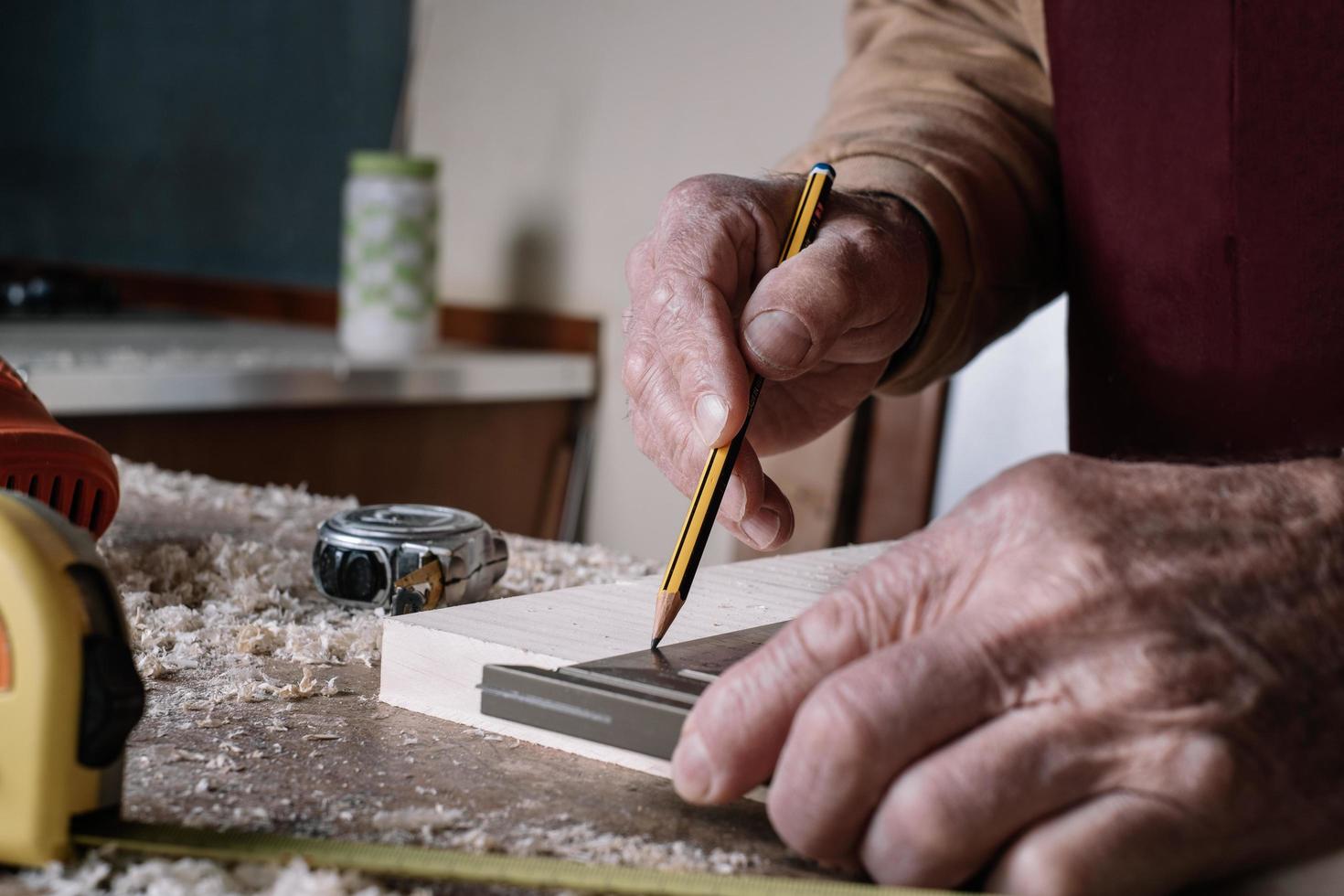 Carpenter making measurements on a table photo