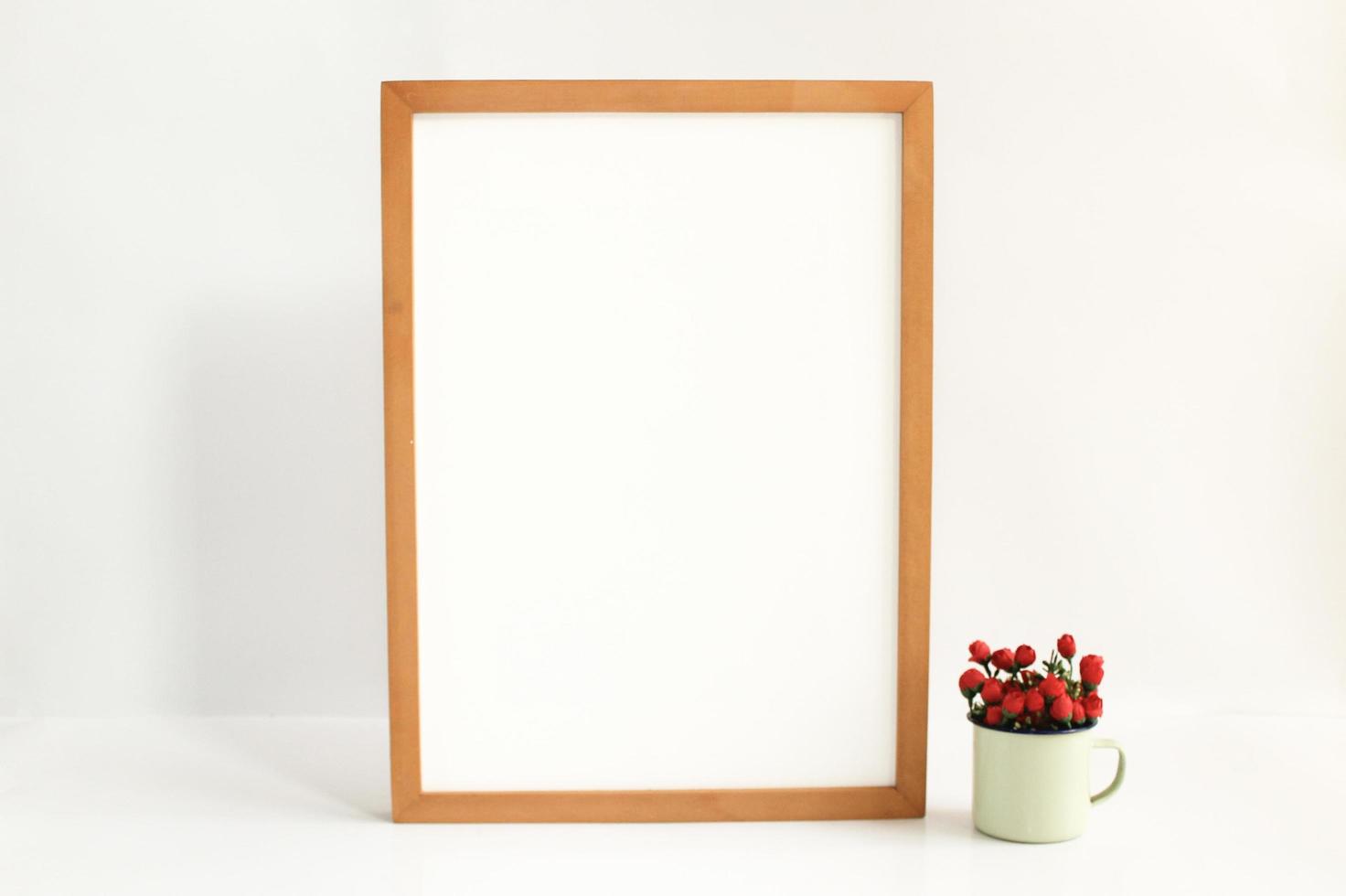 Blank wooden frame with flowers photo