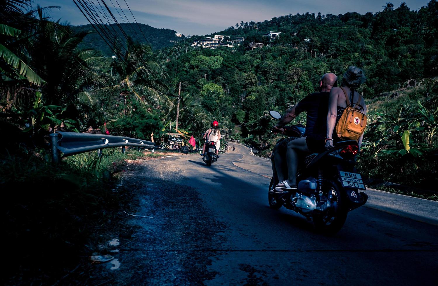 Person riding motor scooter during daytime photo