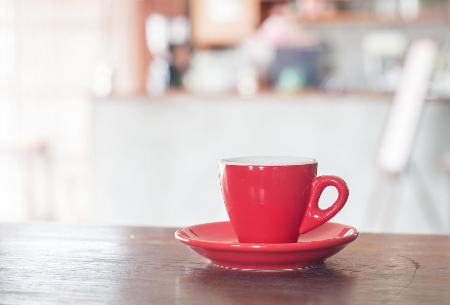 Red coffee cup in a cafe photo