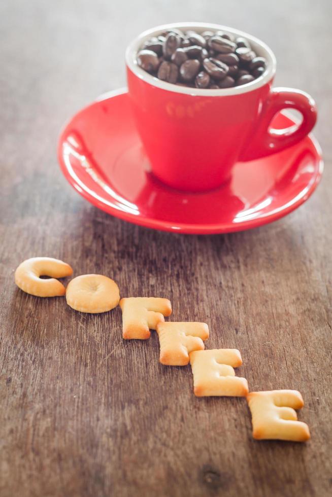 Coffee alphabet biscuits with coffee beans in a cup photo