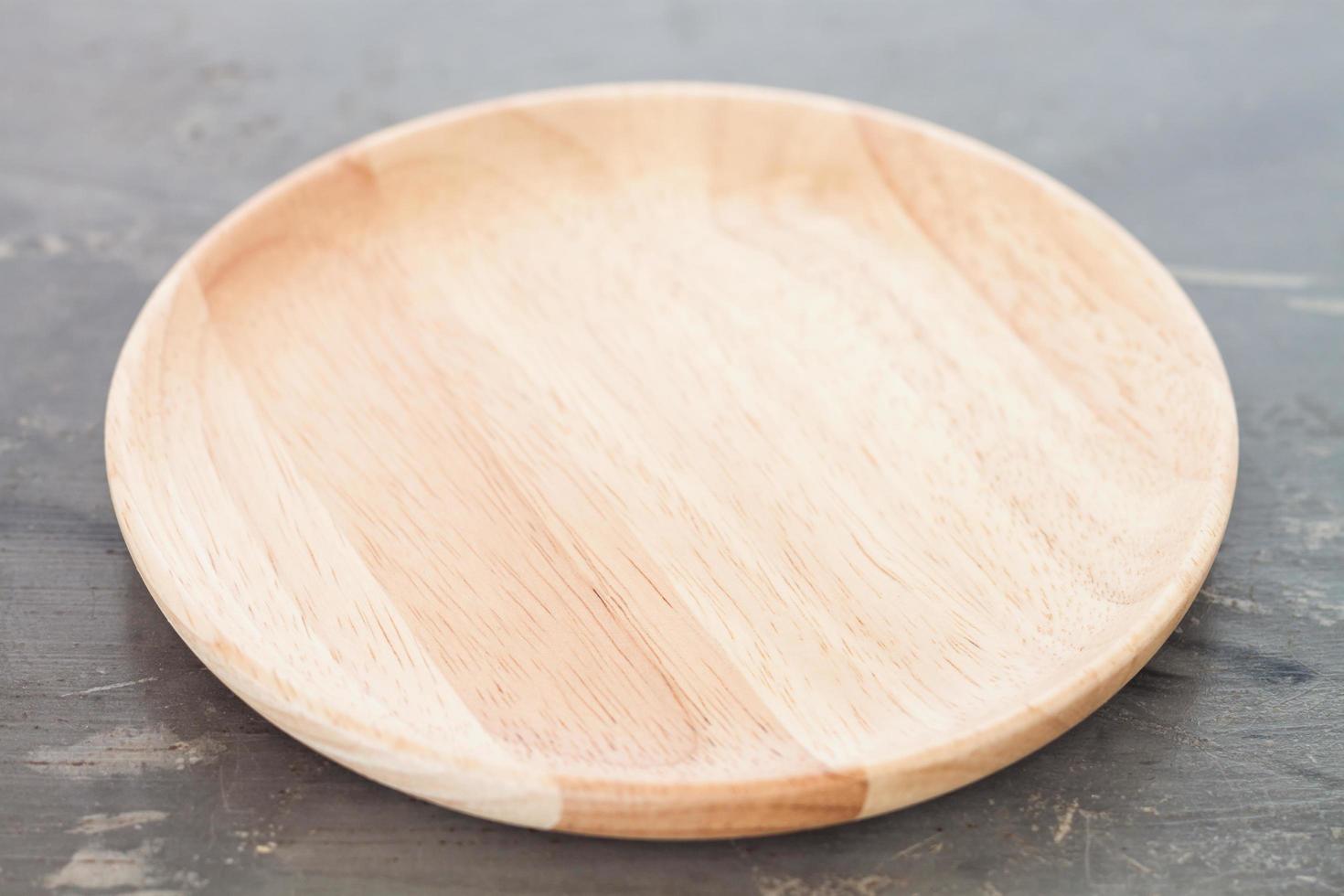 Wooden plate on a gray background photo