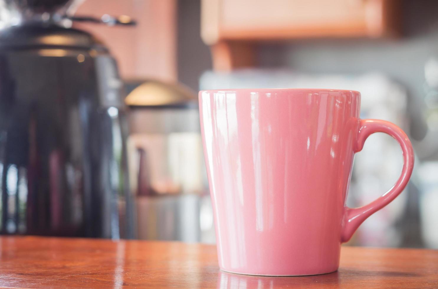 Pink coffee mug in a cafe photo