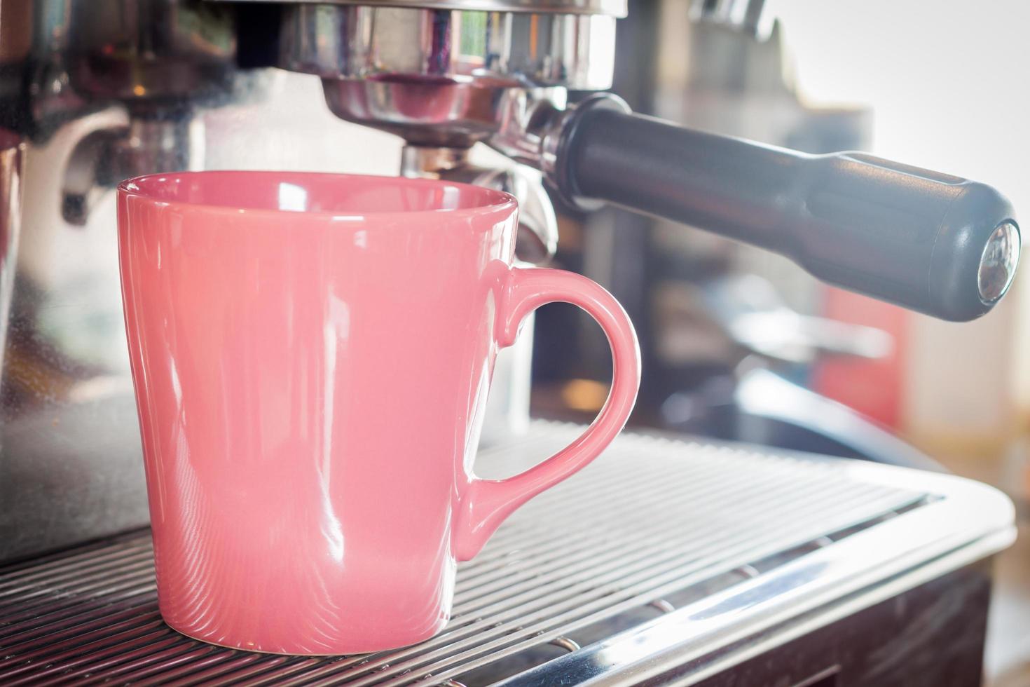 Pink coffee mug in coffee shop photo