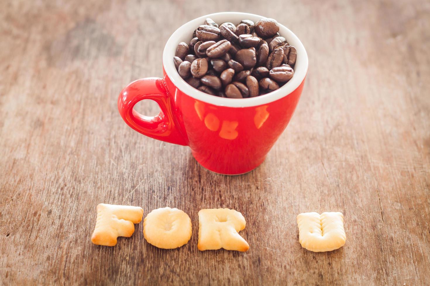 For u alphabet biscuits with a red coffee cup photo