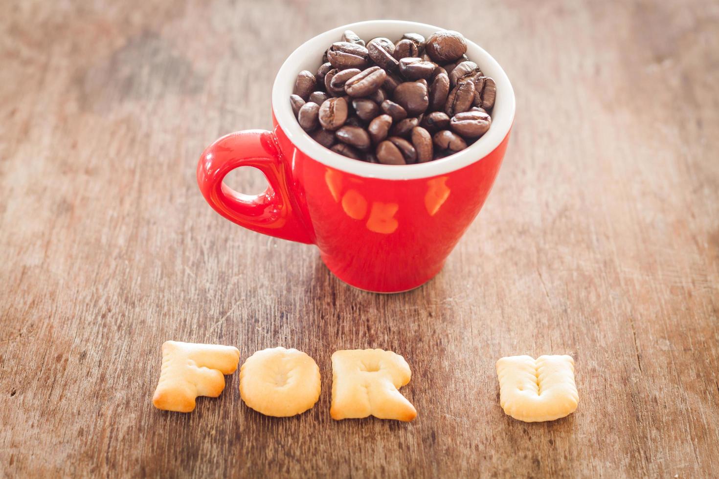 para u galletas del alfabeto con una taza de café roja foto