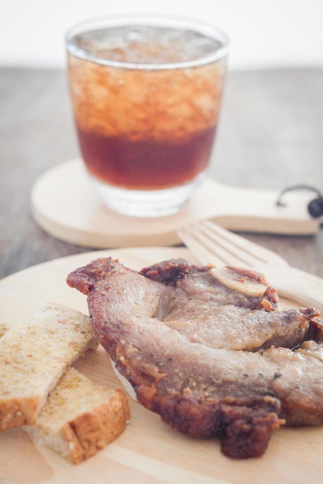 Pork steak and a soda photo