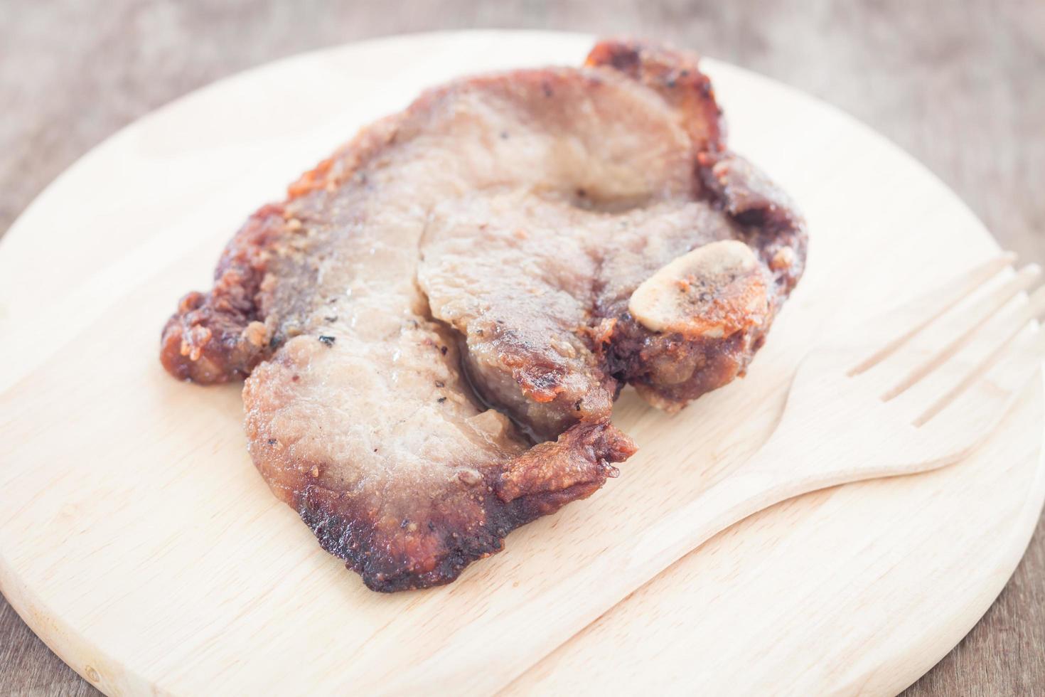 Pork steak and fork on a plate photo