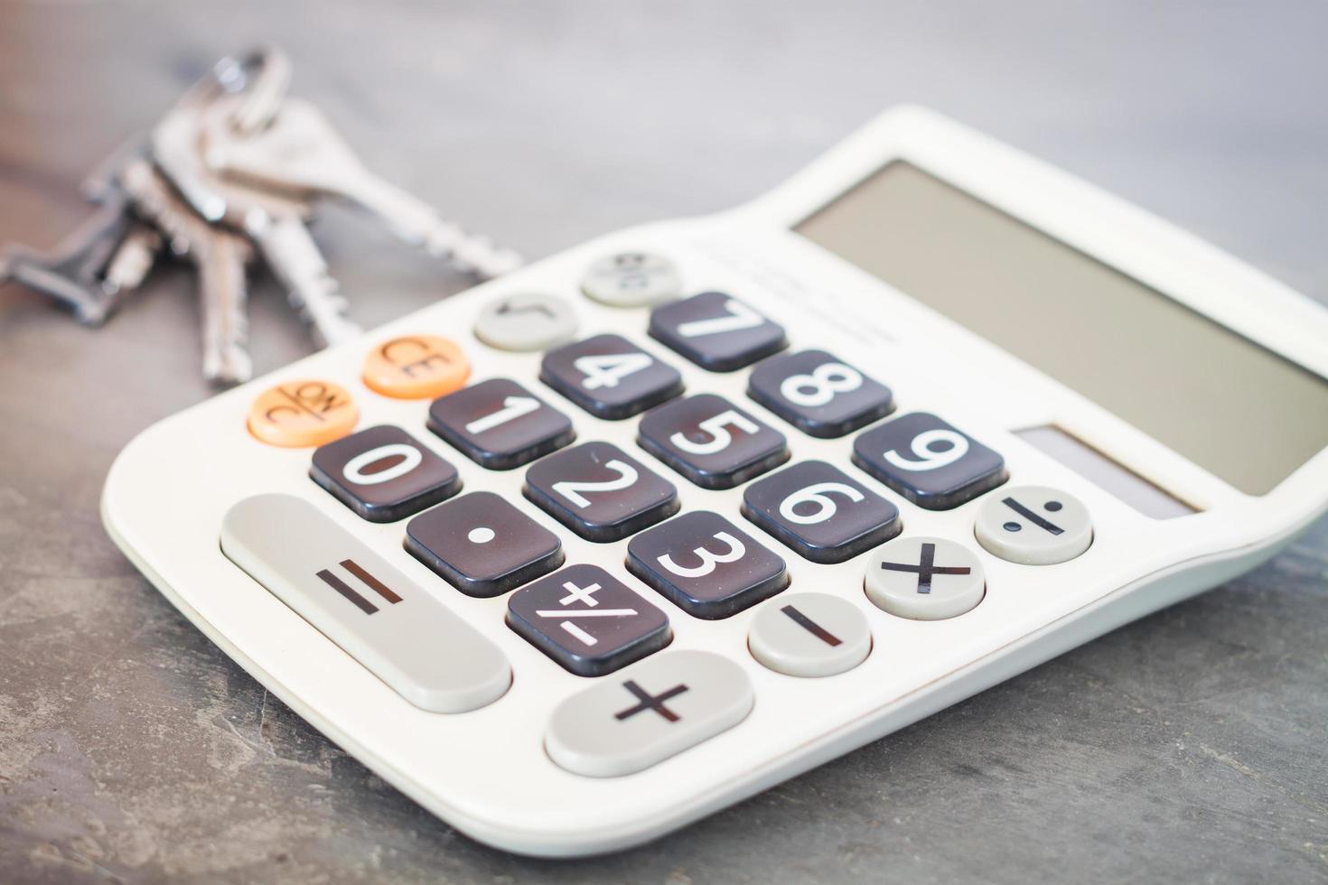Calculator with keys on a grey background photo