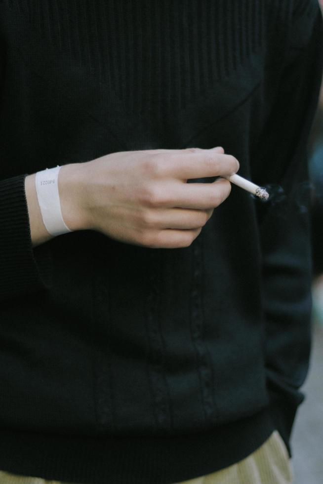 Man holding a cigarette in his hand photo