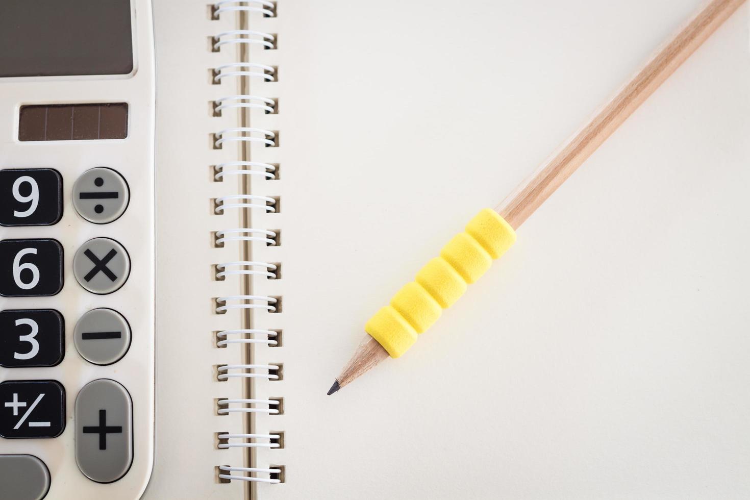 Top view of an open blank notebook with a pencil photo