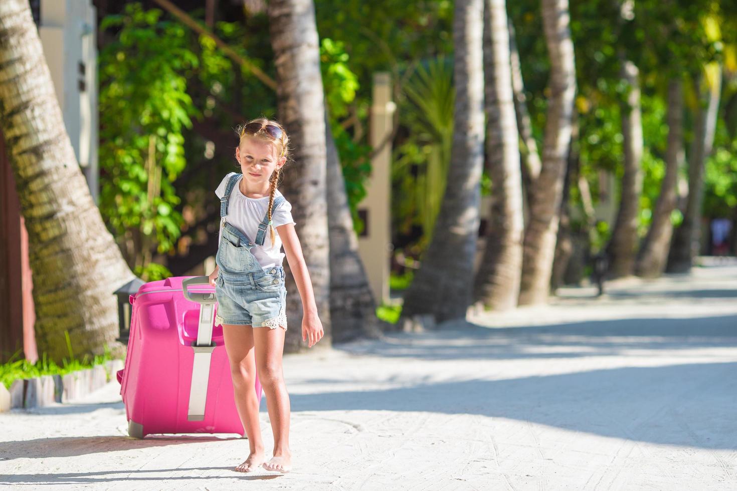 Girl walking with luggage photo