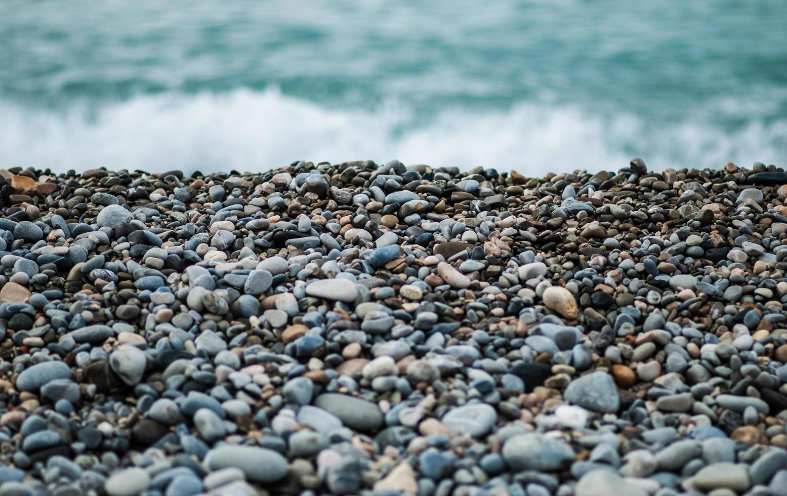 Gray and black stones near sea at daytime photo