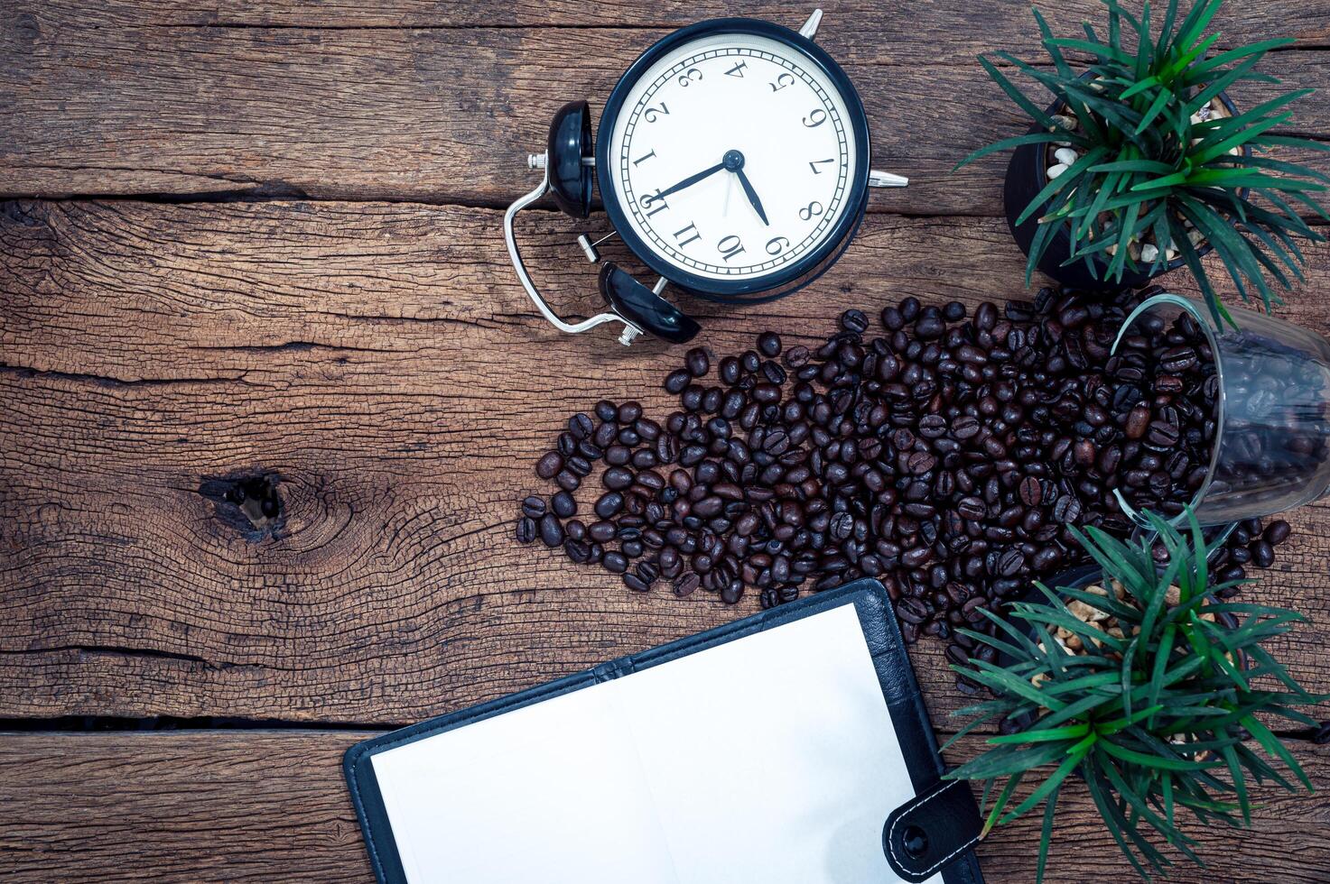 Coffee, notebook and alarm clock photo