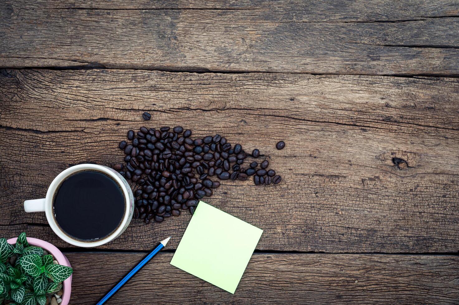 Wooden desk with coffee, top view photo