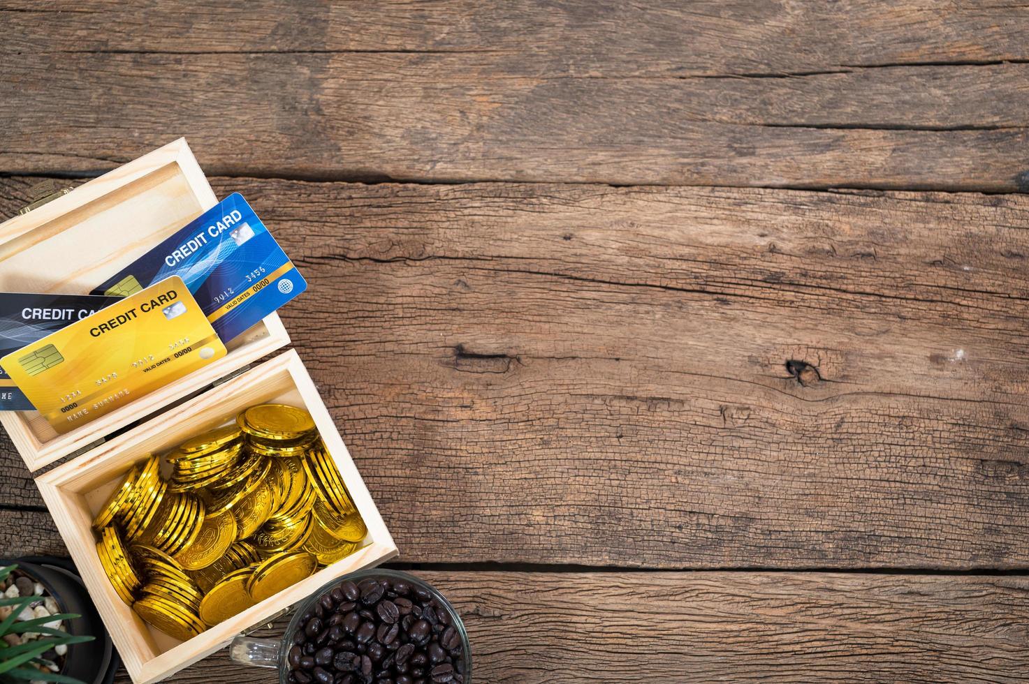 Wooden desk with coins and credit cards photo