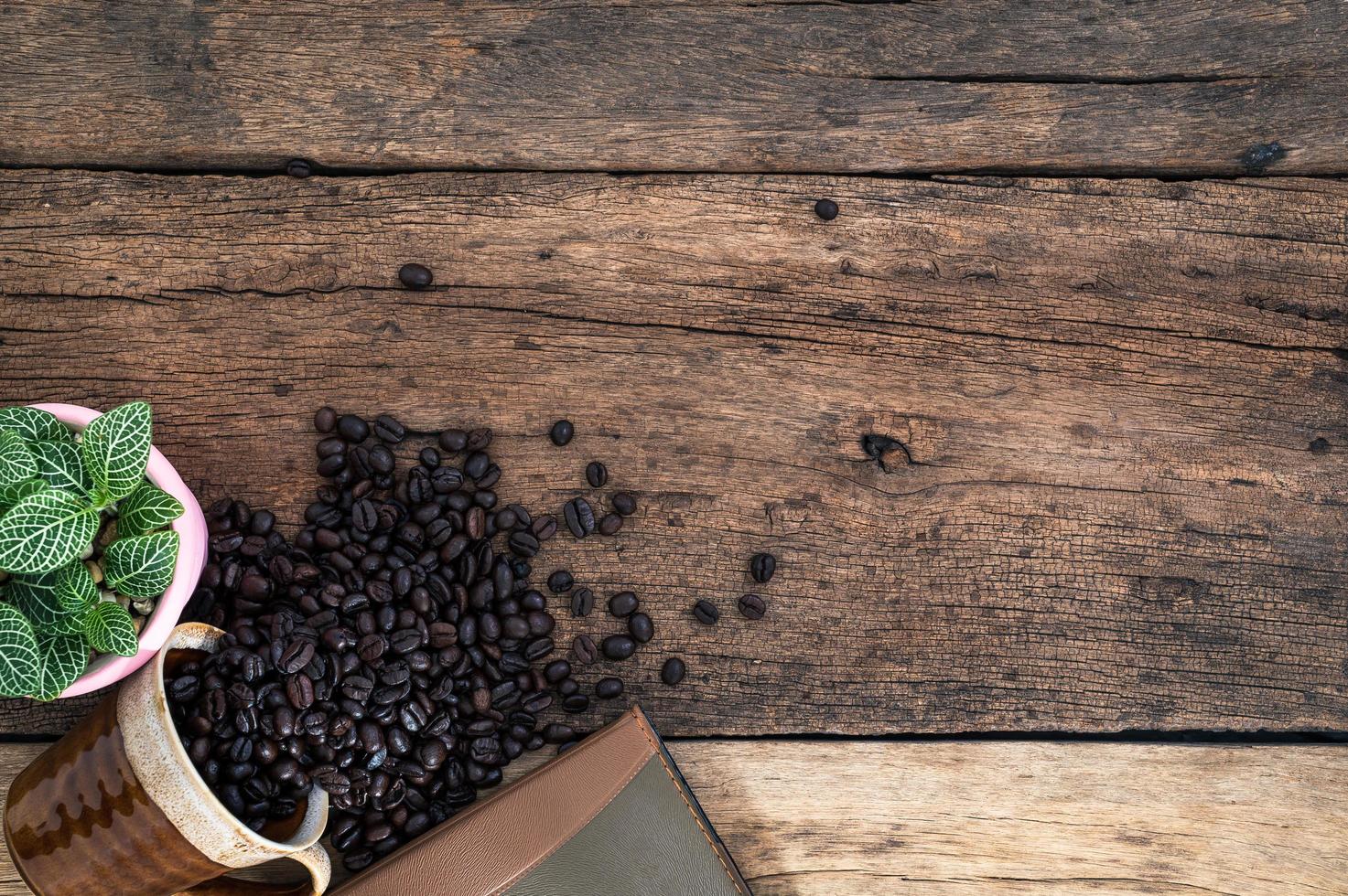 Wooden desk with coffee beans photo