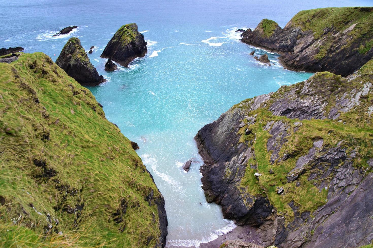 Cove beach surrounded with rock walls photo