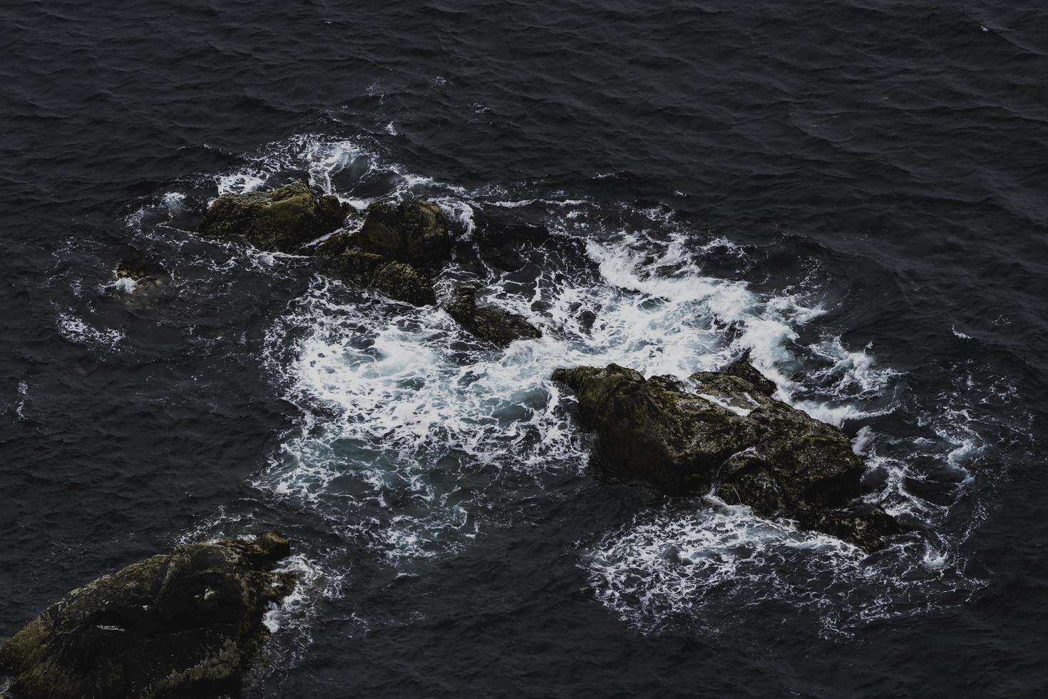 Waves crashing into rocks photo