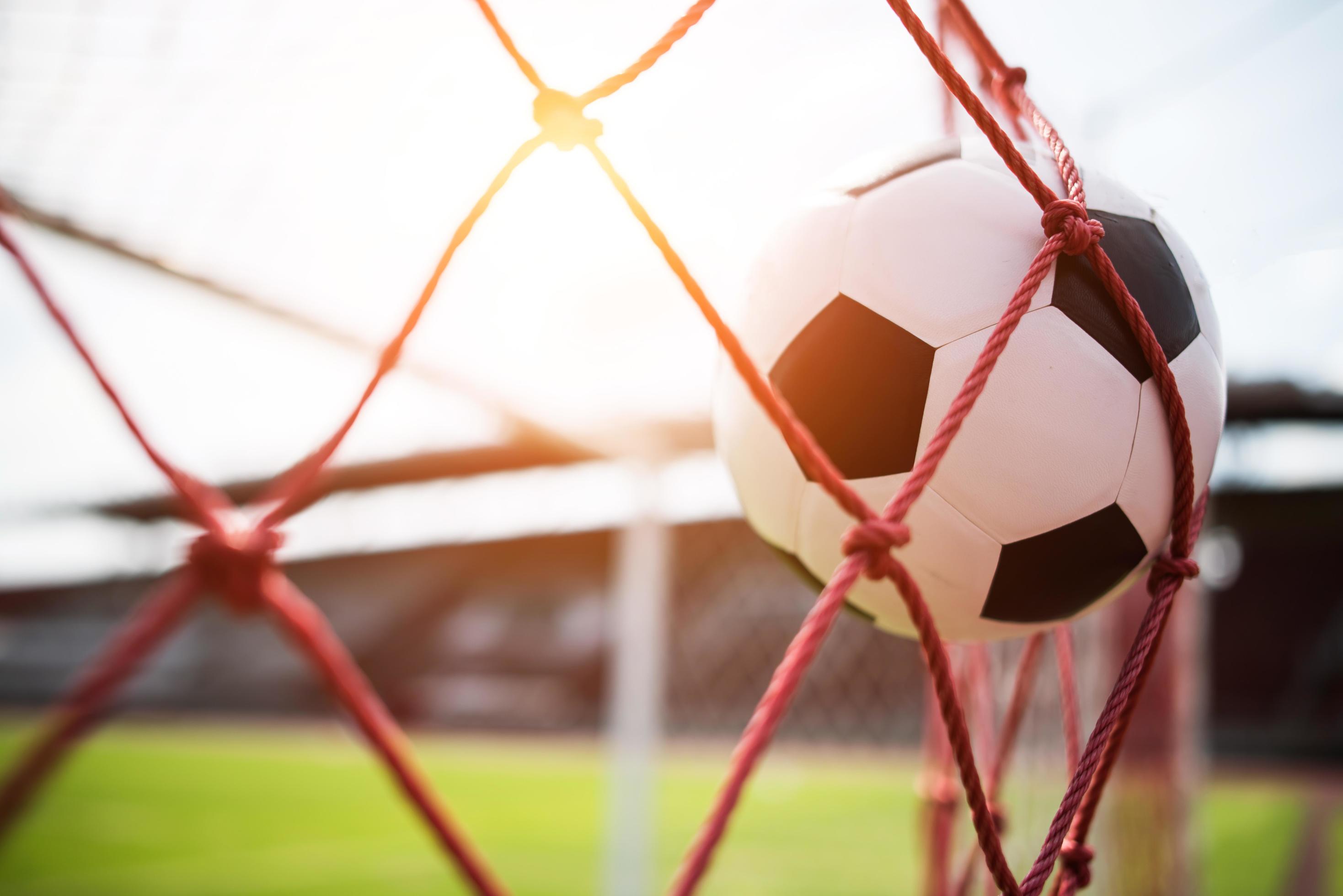 Soccer Ball Soars Into Goal Net Stock Photo