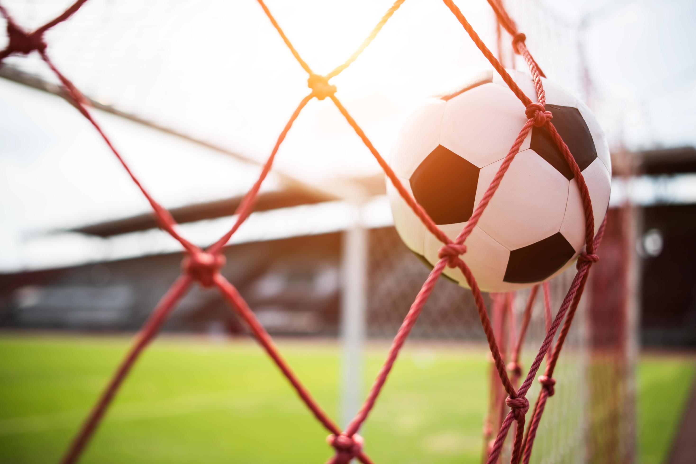 Soccer Ball Soars Into Goal Net Stock Photo