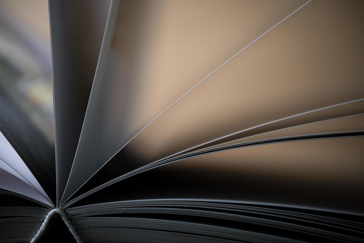 Close-up of an opened book on a wooden table photo