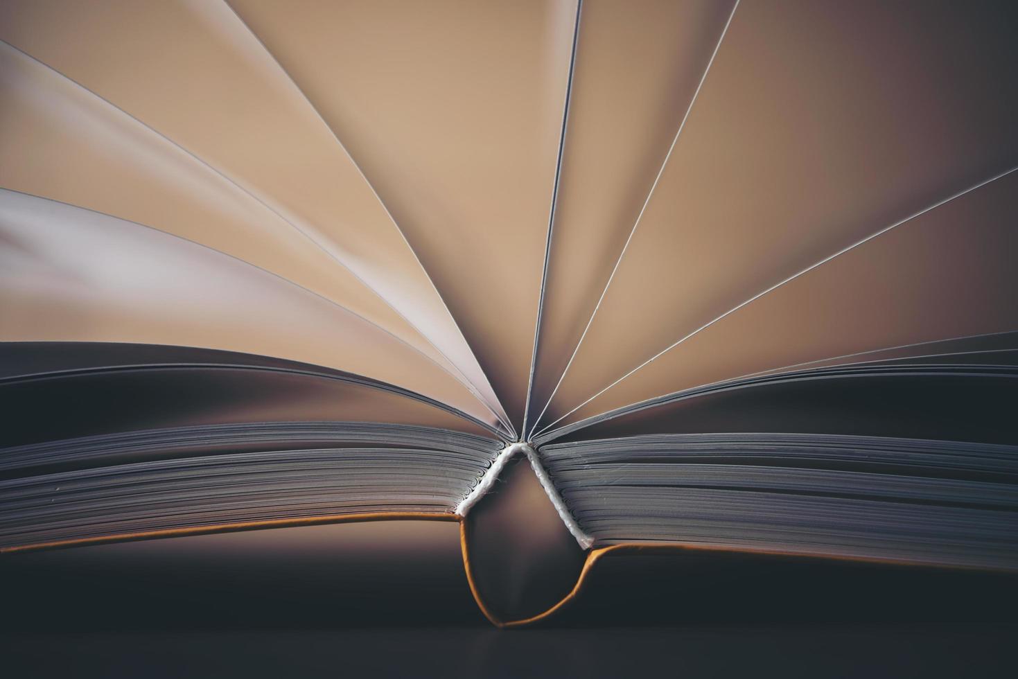 Close-up of an opened book on a wooden table photo
