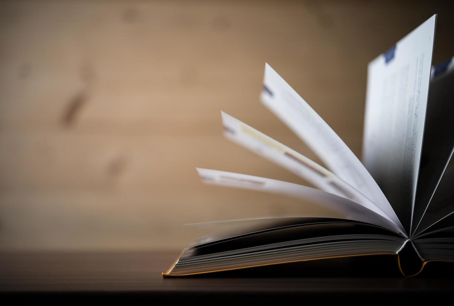 Close-up of an opened book on a wooden table photo