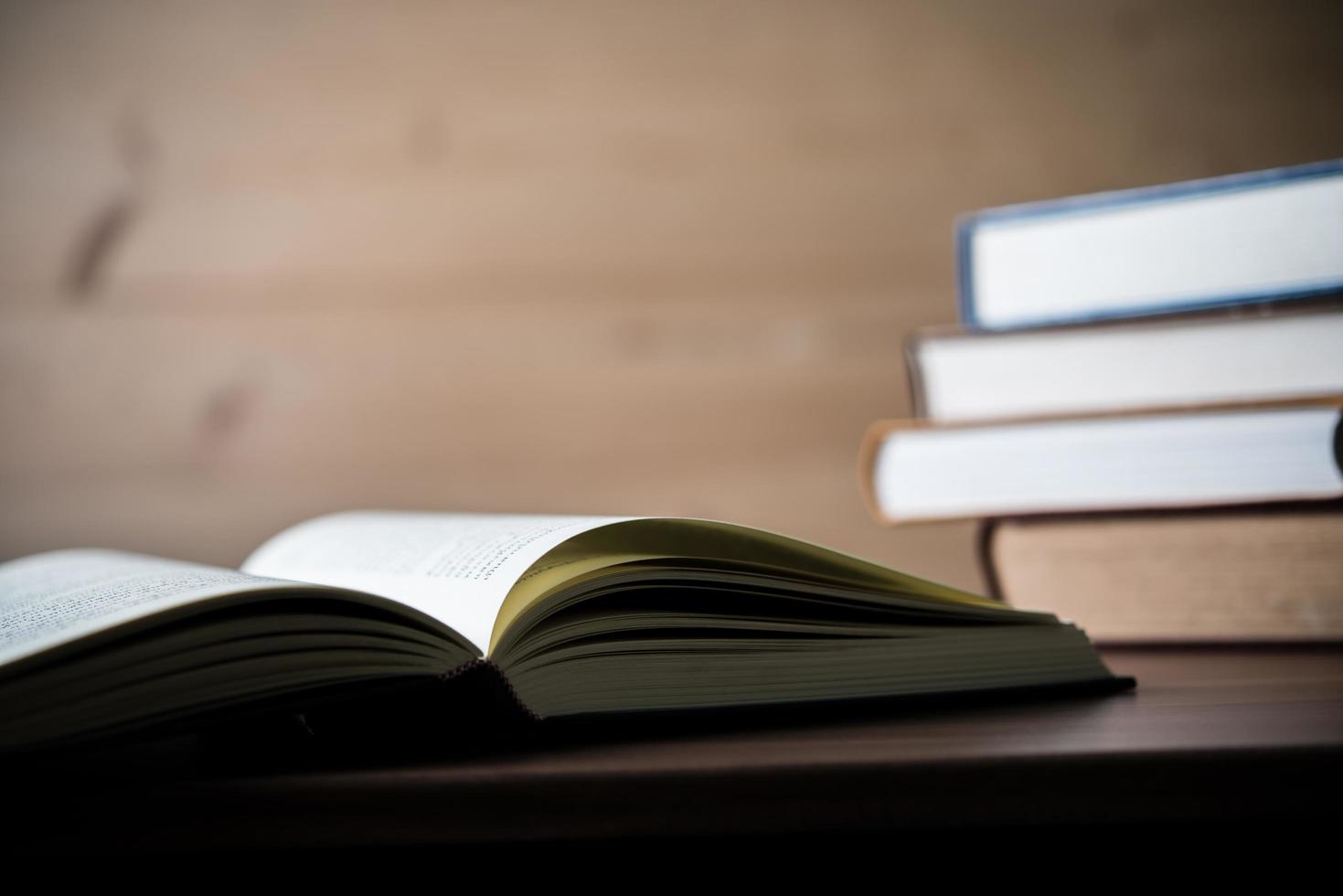 Stack of books on wooden table photo