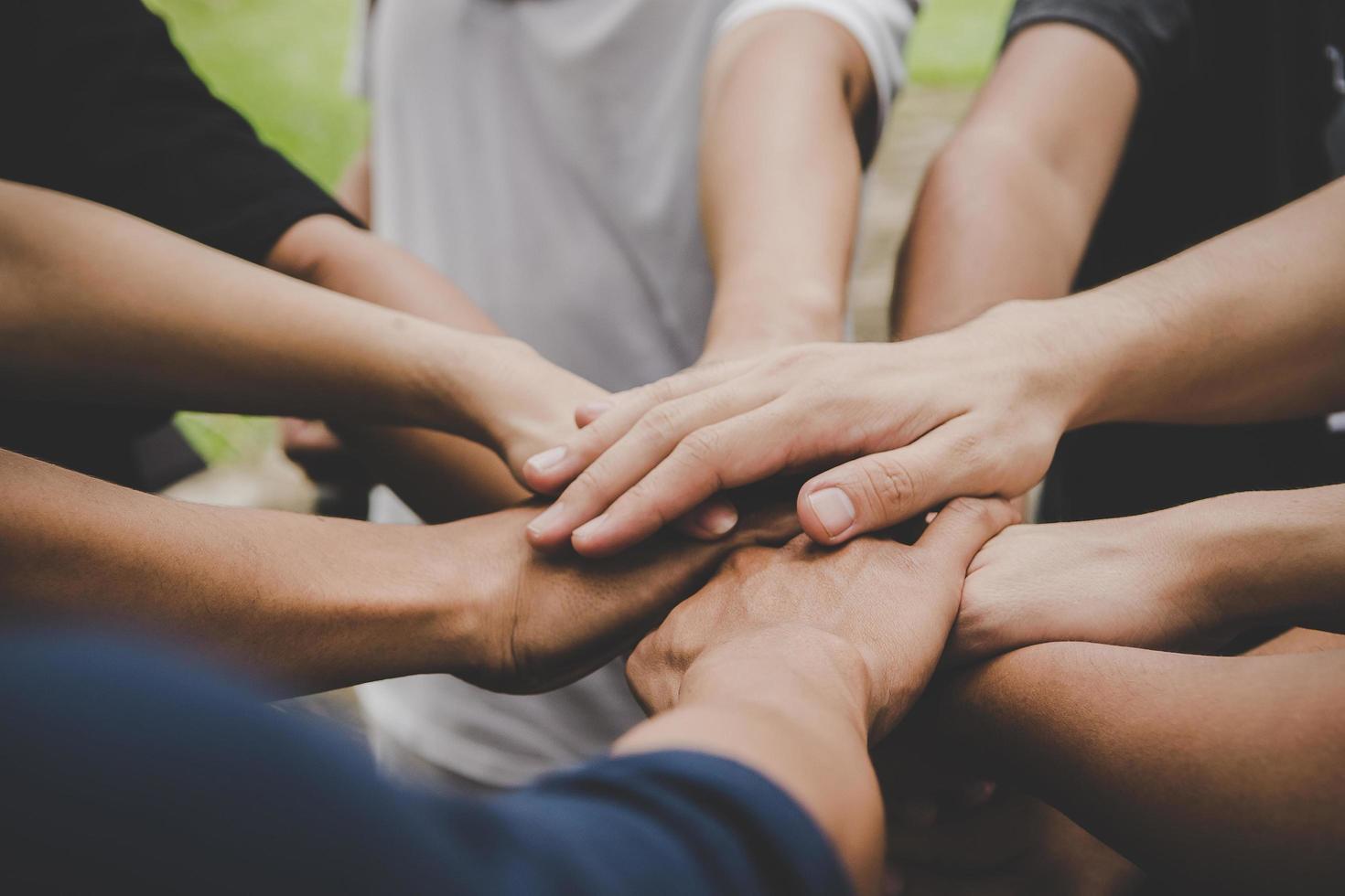 Several people join hands together photo