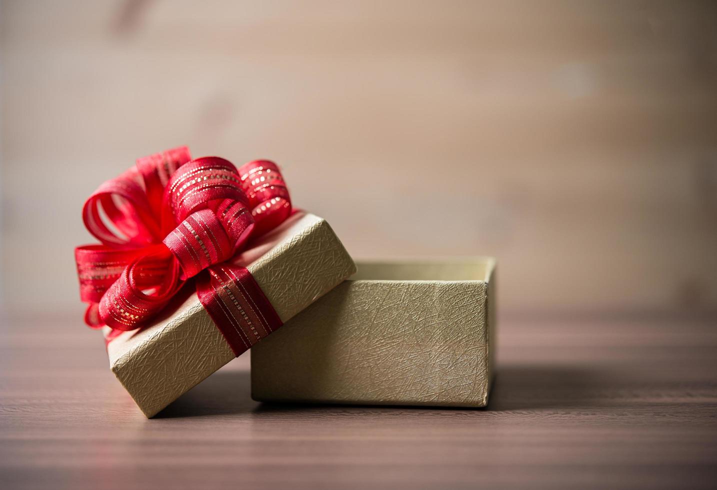 Small gift box on wooden background photo