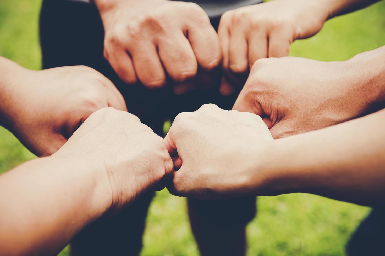 Several people join hands together photo