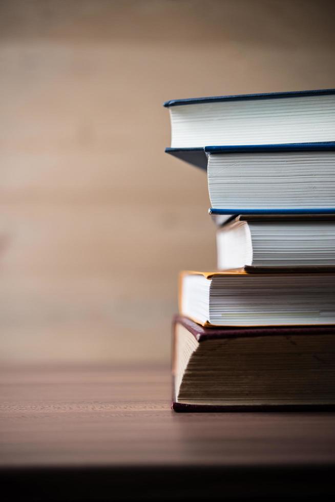 Stack of books on wooden table photo