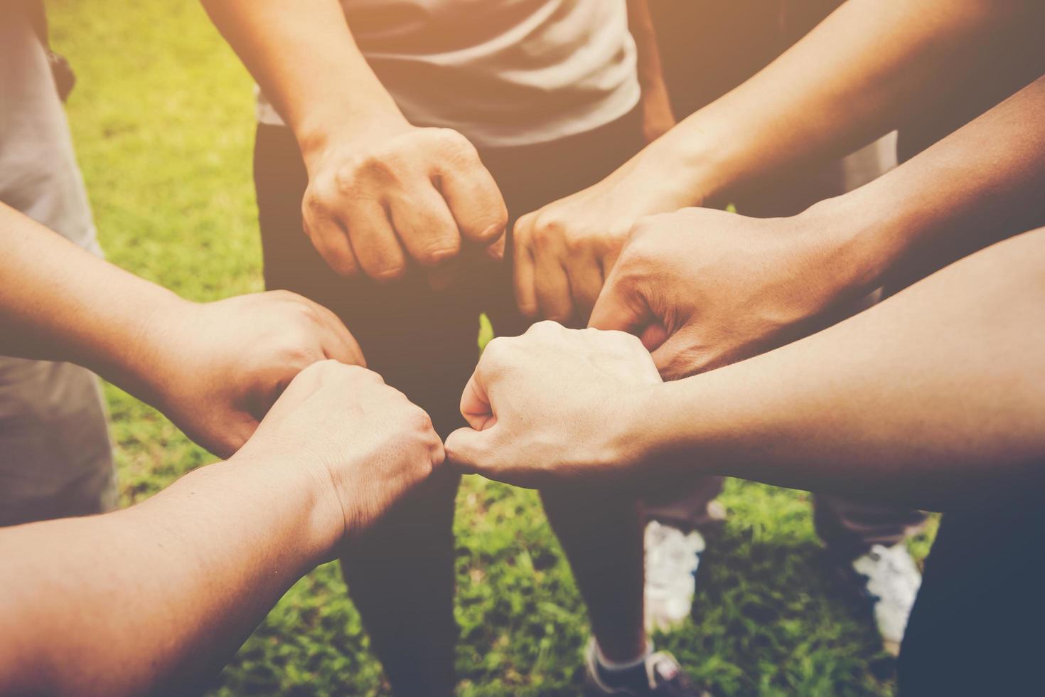 Several people join hands together photo