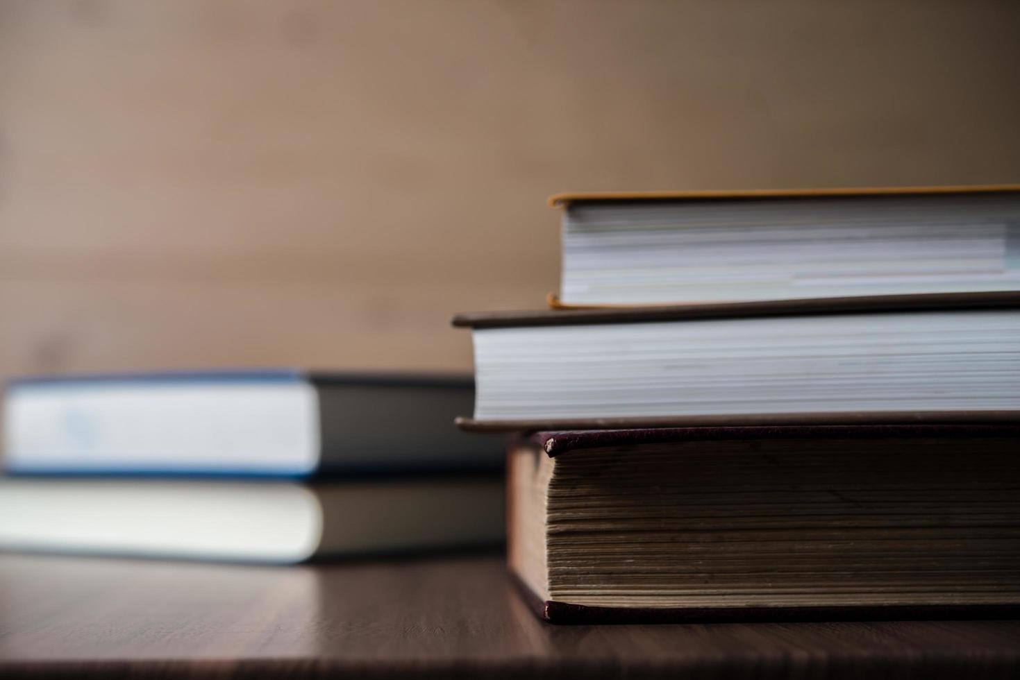 Stack of books on wooden table photo