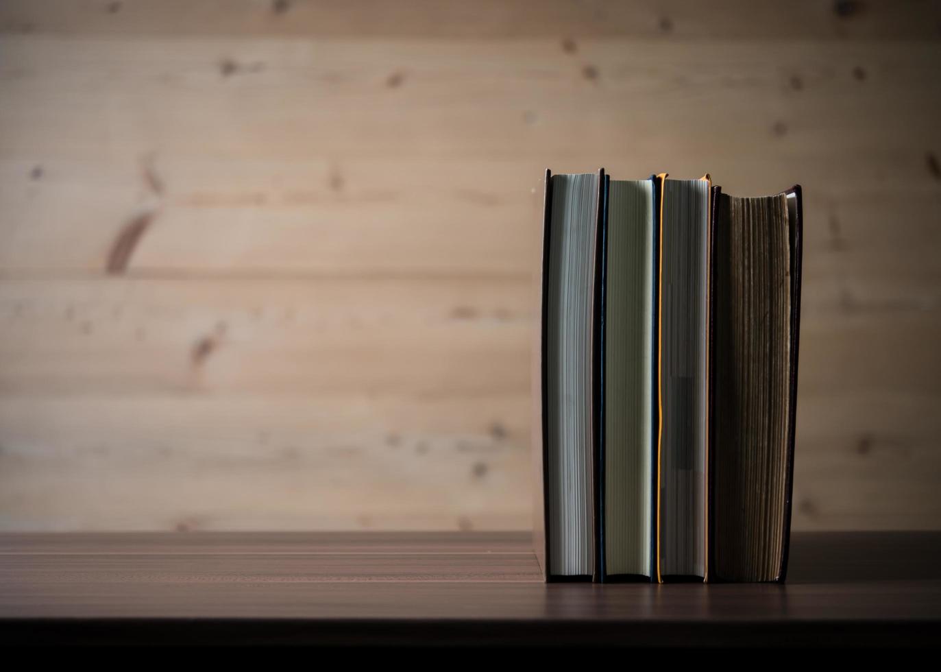Stack of books on wooden table. photo