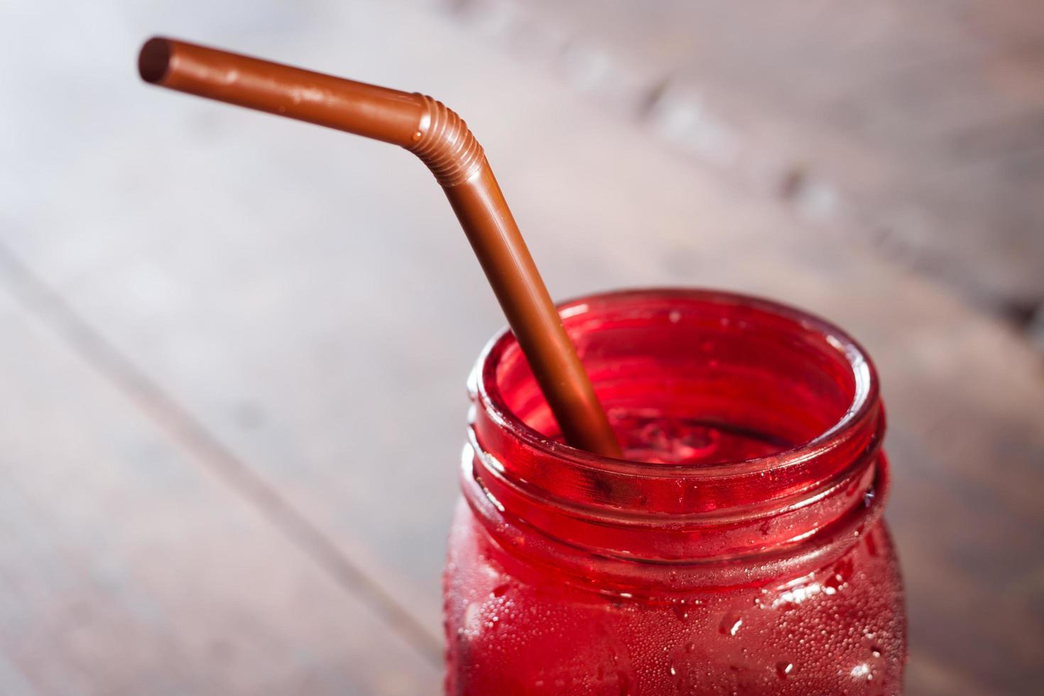 Close-up of a red glass jar on a wooden table photo