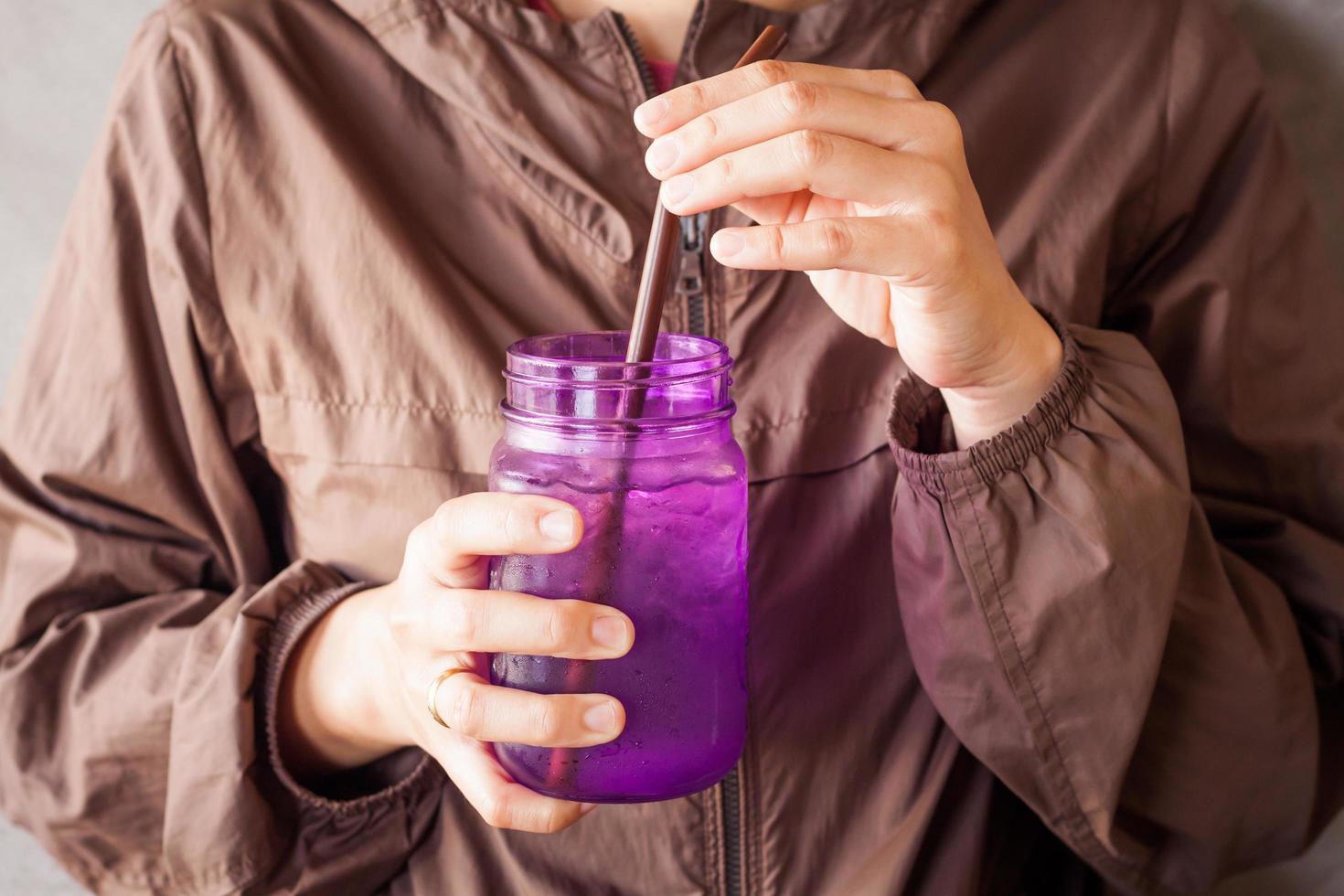 Person holding a purple glass photo