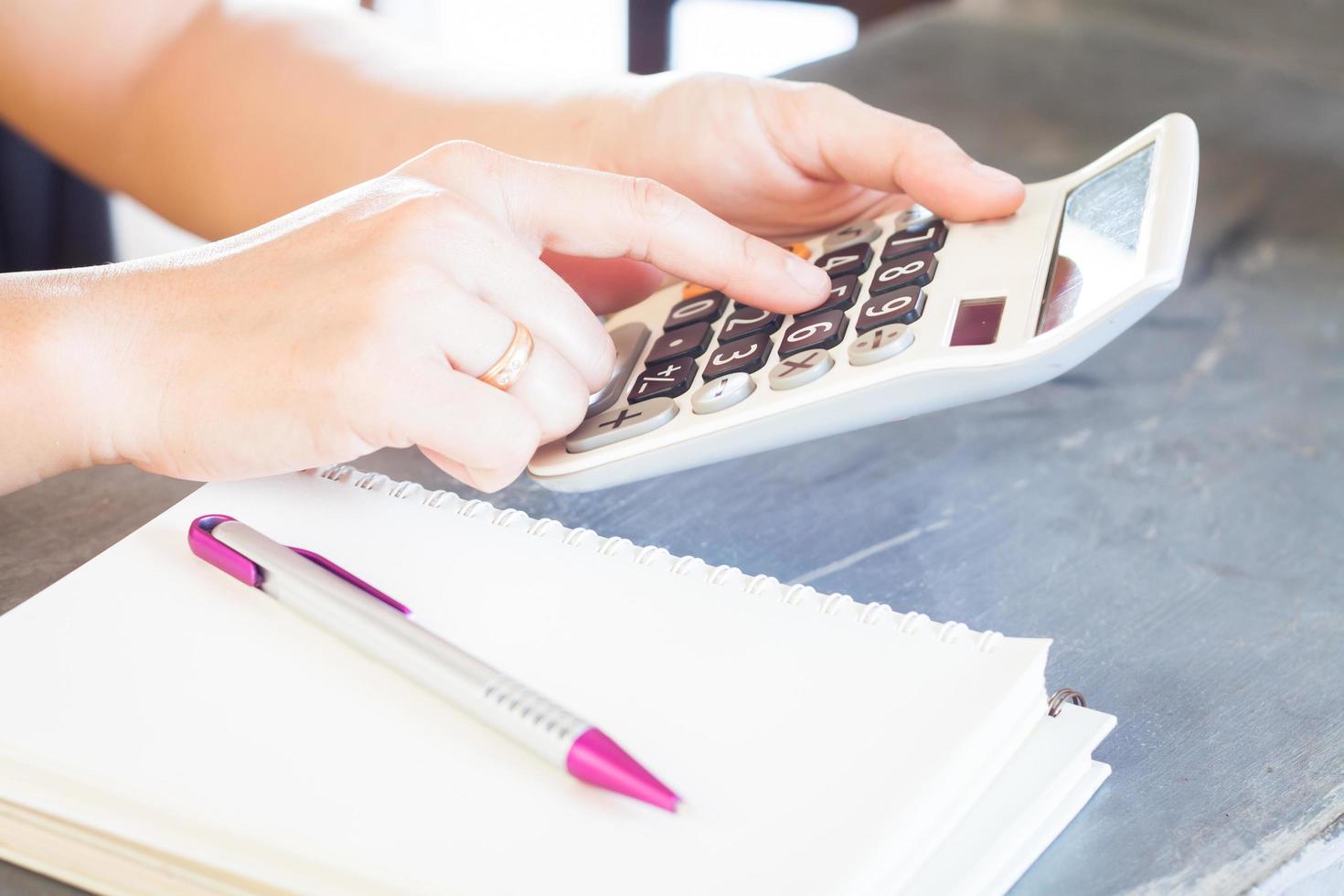 Close-up of a person using a calculator photo